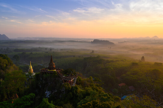 View of Buddhism temple Thamma Park padoga on hill at sunrise in Ban Khao Na Nai village in Phanom, Surat Thani, Thailand
