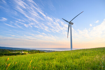 View of Wind turbine in glass field on hill