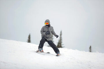 Fototapeta na wymiar Skier in mountains on snowy slope
