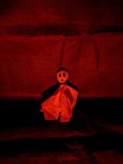 paper ghost for halloween with red and black lighting