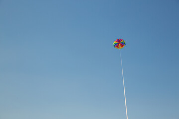 Parasailing on the sea, in blue sky. Concept of vacation, extreme sports on a beach