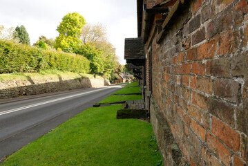 empty main road through a village past a row of cottages