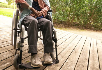 Obraz premium Close-up of the legs of a disabled woman in a wheelchair.