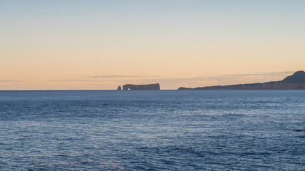 Famous rock of Percé in the horizon during the golden hour