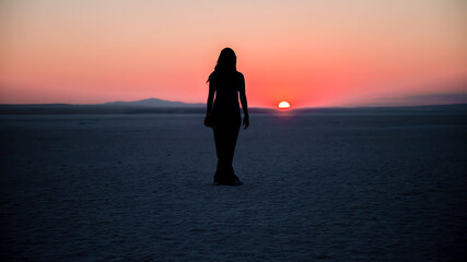 Unidentified woman watching the sunset at Salt Lake Tuz Golu in Ankara, Turkey