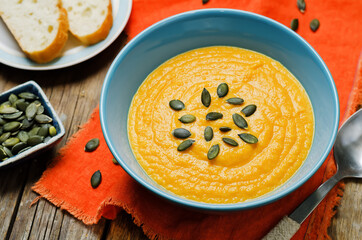 Sweet potato carrot soup on a wood background