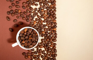 Coffee beans in a coffee Cup on a brown and beige background