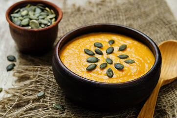 Sweet potato carrot soup on a wood background