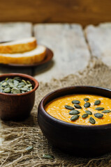 Sweet potato carrot soup on a wood background