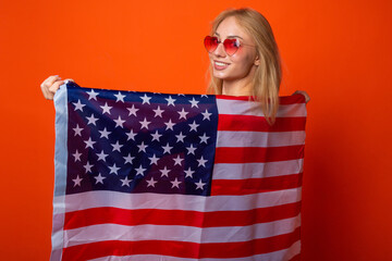 beautiful young woman with american flag on red background