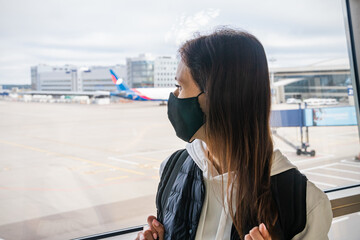 Fototapeta premium Woman wearing a mask for prevent virus in international airport. Protection against Coronavirus and COVID-19