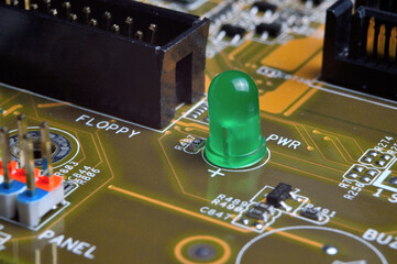 green LED on the computer motherboard. close-up.