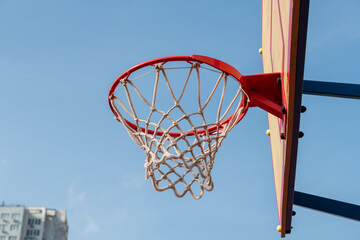 Nice red basketball rim and board on blue sky background sport health