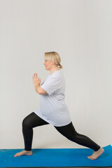 Naklejka premium beautiful young plump female in a white t-shirt goes in for sports on a white background