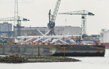 Fototapeta na wymiar Superyacht. Sailing yacht. Transport of the mast on a barge. Cranes. Shipbuilding industry. Ship.