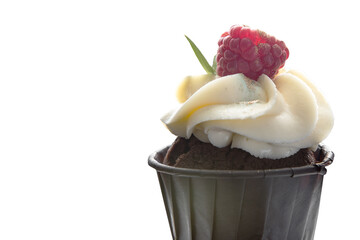 Sponge cake with cream and raspberries in a paper Cup on a white isolated background. Space for text