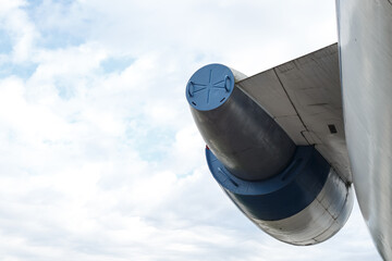 Airplane turbine against a cloudy sky. Fragment of the plane