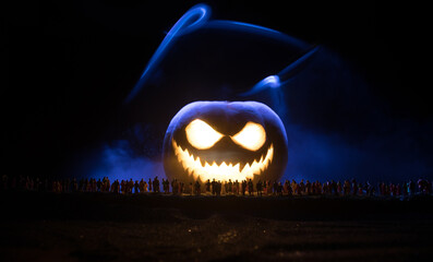 Halloween concept. Blurred silhouette of giant Jack-o-lantern pumpkin with scary smiling face...