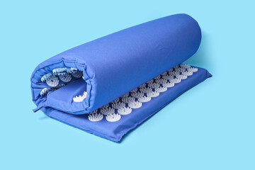 acupuncture massage mat on blue background copy space