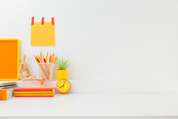 Student creative desk mock up with colorful office supplies and blue wall. Back to school or...