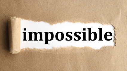 impossible, text on craft torn paper on a white backing