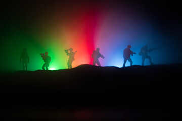 Naklejka na ściany i meble Azeri army concept. Silhouette of armed soldiers against Azerbaijani flag. Creative artwork decoration. Military silhouettes fighting scene dark toned foggy background.