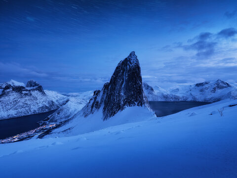 Mountain Segla and starry night sky, Senja islands, Norway. High mountains at the winter time. Winter landscape with night sky. Norway travel - image