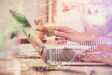 Multi exposure of woman hands typing on computer and financial graph hologram drawing. Stock market analysis concept.