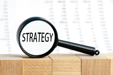 Look closely and STRATEGY with a magnifying glass , business concept image with soft focus background