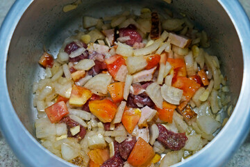 Seasonings (tomatoes, meat, bacon, onion, garlic, salt, black pepper, olive oil) in the pressure cooker, Brazil 