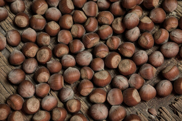 Still life with Walnut kernels and whole walnuts on rustic old wooden table. Creative table decoration.
