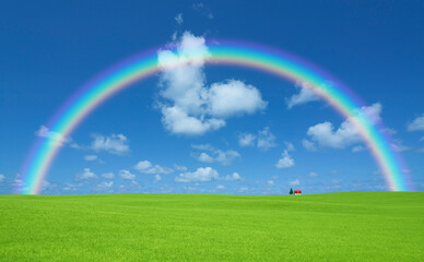 草原の赤い屋根の家と雲と虹