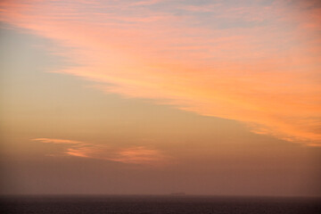 Fototapeta na wymiar sun setting on the horizon the water of the caribbean sea and a boat with people