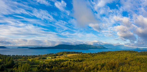 Sunrise View of Orcas Island as Seen from Lummi Island, Washington. Aerial drone view of an island in the San Juan Island archipelago of the Salish Sea area of western Washington state.