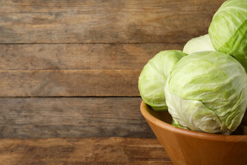 Ripe white cabbage on wooden background, closeup. Space for text