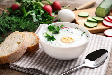 Delicious cold summer soup with kefir served on wooden table