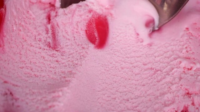 Close up steel ice cream scoop is scooping vanilla flavor ice cream meat.