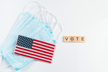 Vote now. Voting concept for the November 3 elections. Medical protective masks and USA flag on white background.