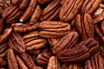 Wellbeing backgrounds, nutritious nut and nutritional value concept with horizontal full frame photograph of group large group of pecan nuts