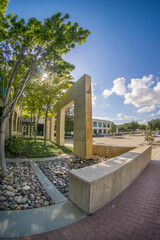 Fototapeta premium Modern concrete fountain structure by office building