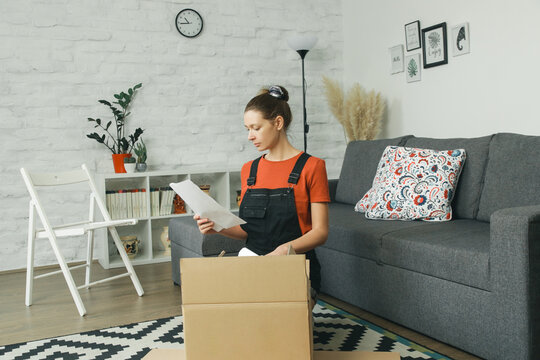 Caucasian Woman At Home Opening Carton Box, Just Delivered Parcel On Address