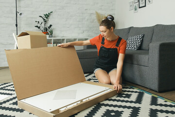 Caucasian woman at home opening carton box, just delivered parcel on address	