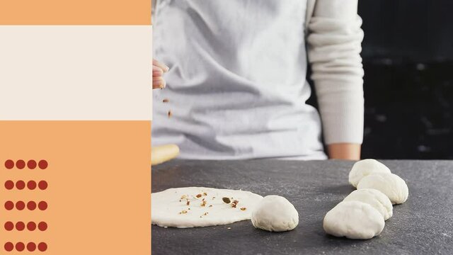 White blank board and orange stripe against mid section of person preparing pizza