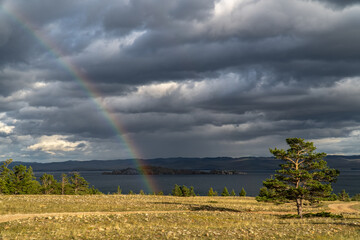 Rain and rainbow on the shore of Baikal
