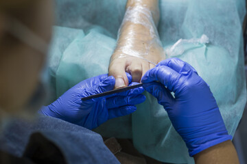 Close up of doctor in gloves making procedure for foot. Pedicure in beauty spa salon. Beautician...