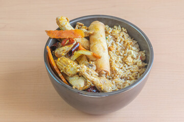 gourmet chinese food in bowl with fried rice, chicken, vegetables and chun kun