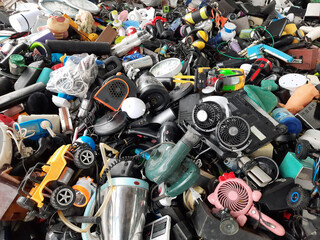 Piles of used electronic and household items are cracked or damaged, Electronic waste is used for...