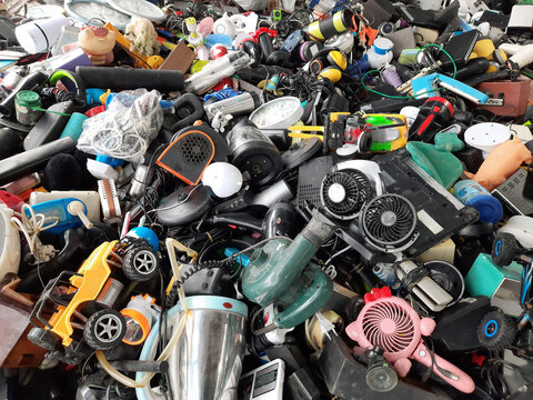 Piles of used electronic and household items are cracked or damaged, Electronic waste is used for reuse and Recycle and is a concern for environmental and waste management.