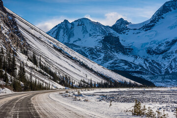 Road through mountains and trees somewhere near Jasper. Alberta, Canada.