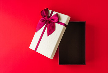 Open Gift box mockup on the red background with. Merry christmas and happy new years.